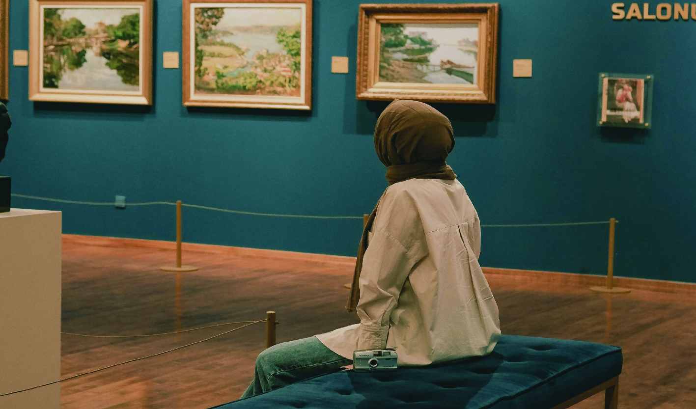 Woman Sitting on a Bench in an Art Gallery